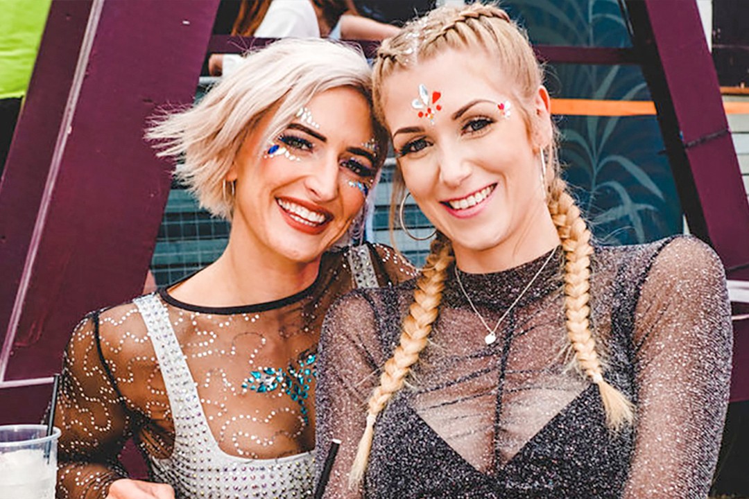 Two women with glitter and gems on their faces